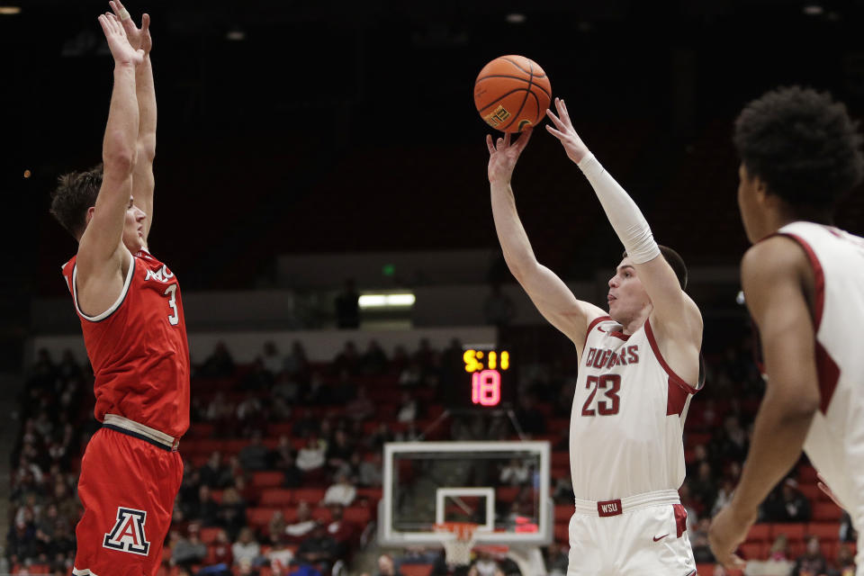 Washington State forward Andrej Jakimovski (23) shoots while pressured by Arizona guard Pelle Larsson (3) during the first half of an NCAA college basketball game, Saturday, Jan. 13, 2024, in Pullman, Wash. (AP Photo/Young Kwak)