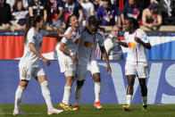 Lyon's Melchie Dumornay, center right, celebrates with Selma Bacha after scoring her side's second goal during the women's Champions League semifinal, second leg, soccer match between Paris Saint-Germain and Olympique Lyonnais at Parc des Princes, in Paris, Sunday, April 28, 2024. (AP Photo/Thibault Camus)