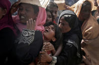 A Rohingya refugee girl reacts as people wait to receive aid in Cox's Bazar, Bangladesh, September 25, 2017. REUTERS/Cathal McNaughton