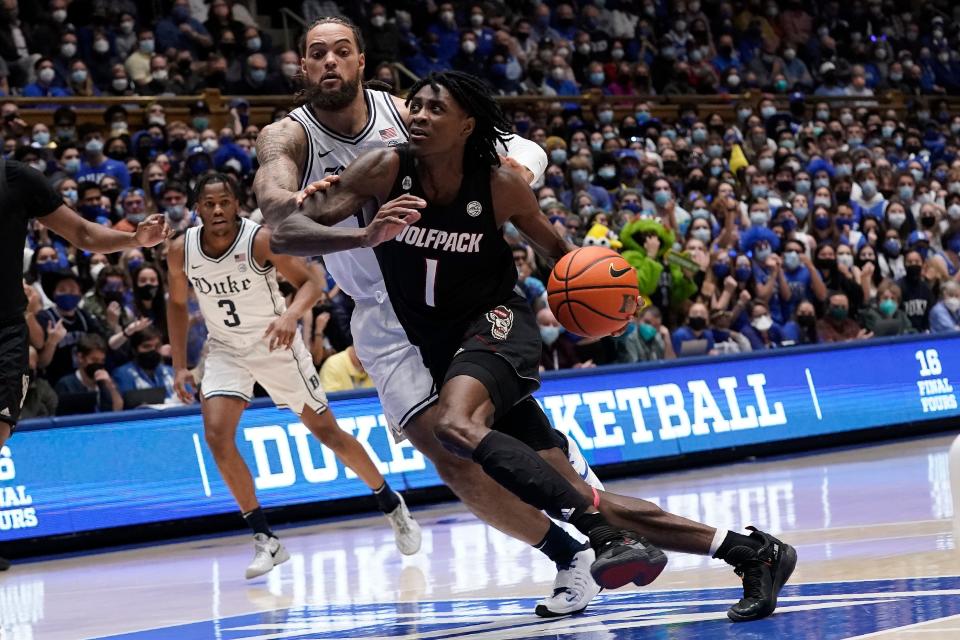 North Carolina State guard Dereon Seabron (1) drives to the basket while Duke forward Theo John defends during the first half of an NCAA college basketball game in Durham, N.C., Saturday, Jan. 15, 2022. (AP Photo/Gerry Broome)