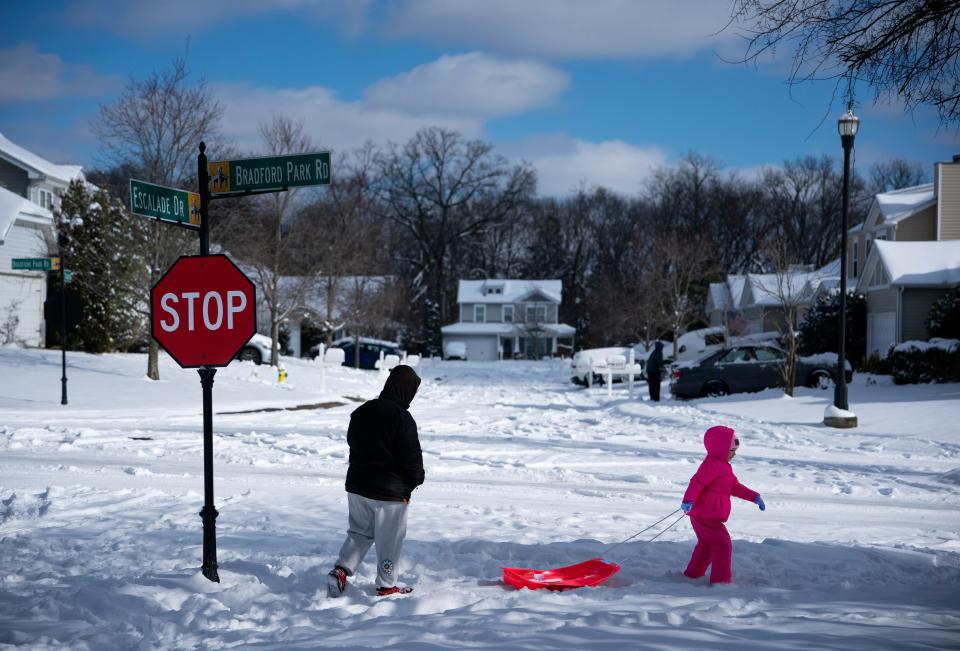 Nora Modert, 6, of Mt. Juliet, Tenn., leads the way to the neighborhood snow hill with her aunt, Amy Stouffer, following closely in Mt. Juliet Tuesday, Jan. 16, 2024.