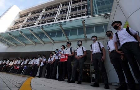 Secondary school students form a human chain as they demonstrate against what they say is police brutality against protesters, after clashes at Wan Chai district, in Hong Kong