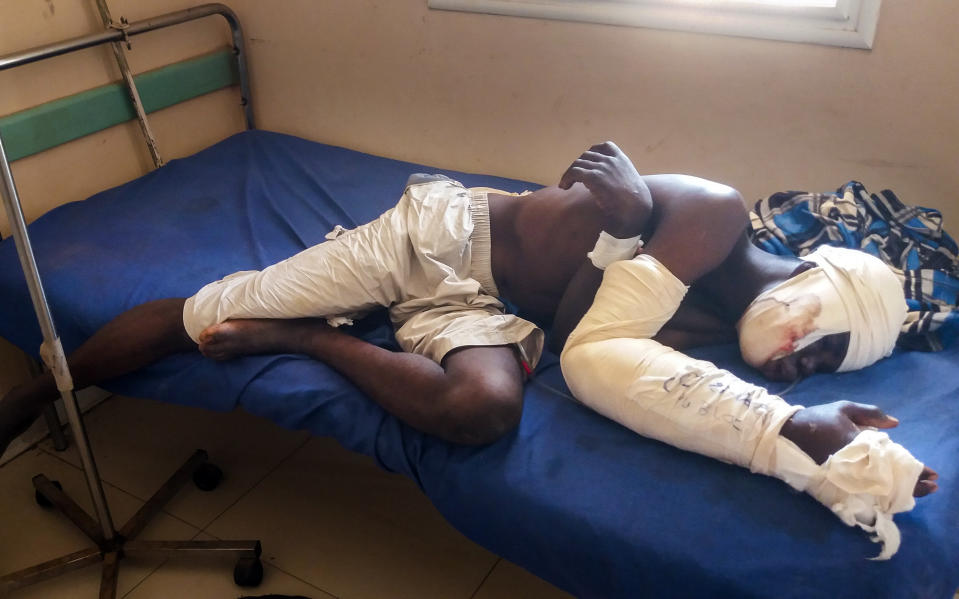 FILE - Saga Saganla, 30, from Diawely, lies on his bed at Somine Dolo hospital in Mopti, Mali, Friday June 24, 2022. Saganla survived an attack by nearly 100 jihadis on motorbikes. Top human rights groups have released new reports in which they documented cases of “war crimes” against civilians in the violent conflict in Africa’s Sahel region where rebels are increasingly fighting in communities under siege. The reports focusing on Burkina Faso and Mali were separately released this week by the Human Rights Watch and Amnesty International. (AP Photo/ Hamidou Saye, File)