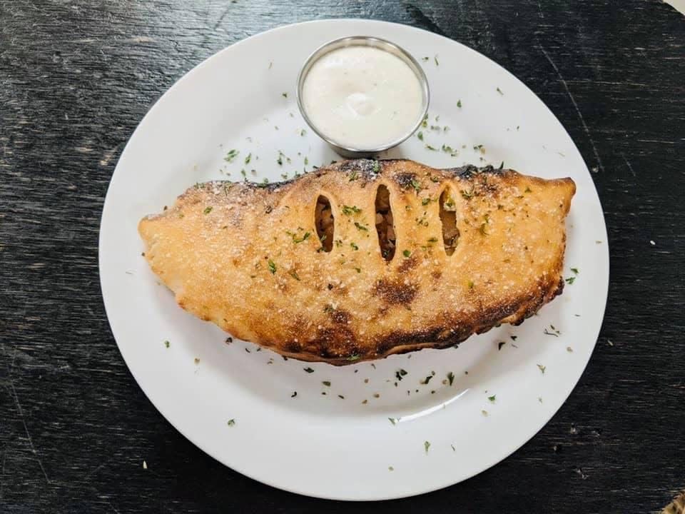In addition to pizzas, Sixpence Kitchen also offers calzones, wings, pastas and more.