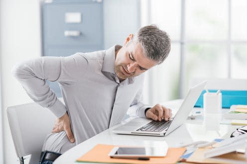 <span class="caption">Our spines are designed to move. </span> <span class="attribution"><a class="link " href="https://www.shutterstock.com/image-photo/stressed-businessman-backache-he-working-office-699891256" rel="nofollow noopener" target="_blank" data-ylk="slk:Stock-Asso/ Shutterstock;elm:context_link;itc:0;sec:content-canvas">Stock-Asso/ Shutterstock</a></span>