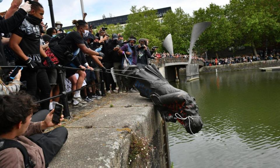 Protesters throwing the statue of Edward Colston into Bristol harbour.