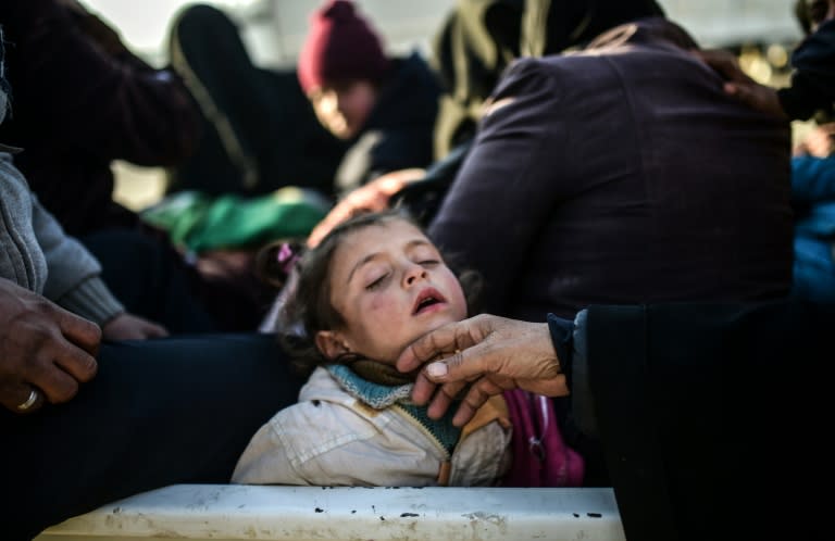 A child sleeps as Syrians fleeing the northern embattled city of Aleppo wait at the Bab al-Salama crossing on the border between Syria and Turkey, on February 5, 2016