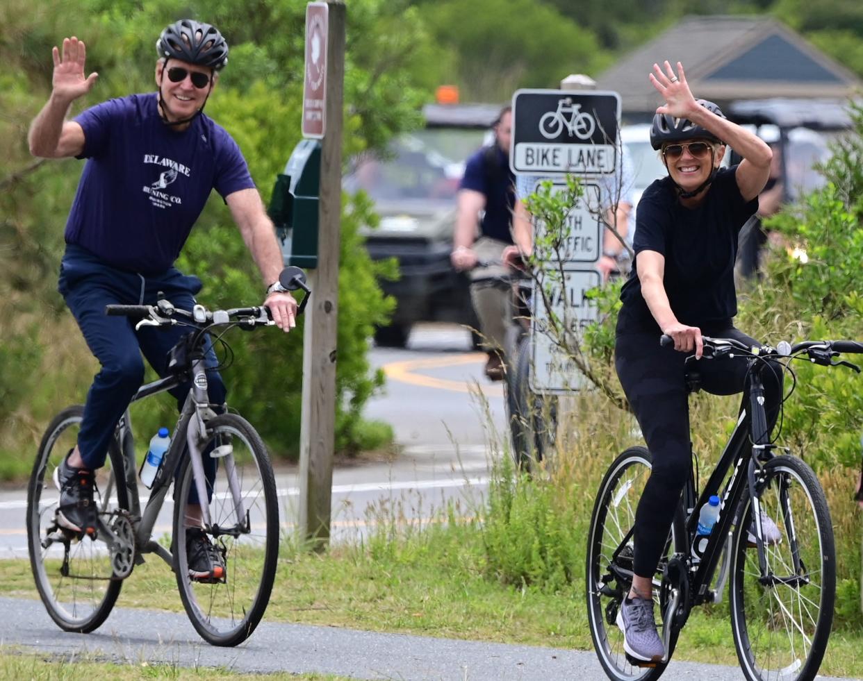 US President Joe Biden (L) and First Lady Jill Biden ride bicycles in Cape Henlopen State Park on June 3, 2021, in Lewes, Delaware. (Photo by JIM WATSON / AFP) (Photo by JIM WATSON/AFP via Getty Images)