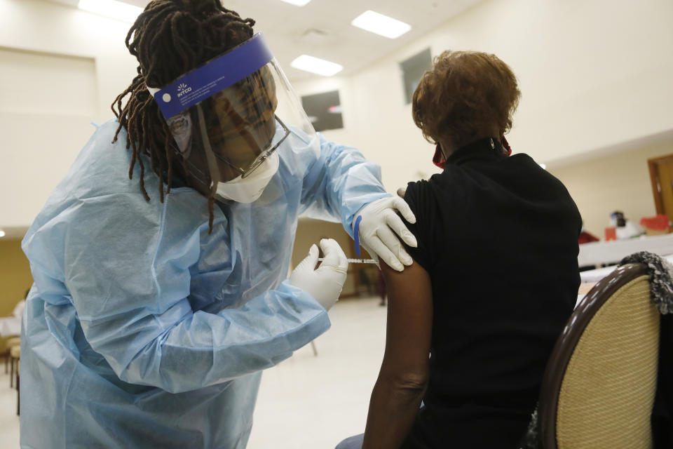 Healthcare workers administer the COVID-19 vaccine to residents living in the Jackson Heights neighborhood at St. Johns Missionary Baptist Church on January 10, 2021 in Tampa, Florida. (Octavio Jones/Getty Images)