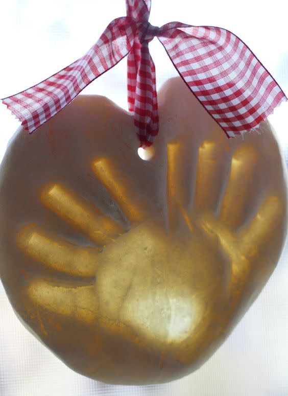 <p>Immortalize your kid’s handprint in salt dough with this easy ornament project even the littlest kids will enjoy having a (ahem) hand in. Hang them from the tree or mantle with pretty ribbon.</p><p><em><a href="https://www.nestofposies-blog.com/2011/11/salt-dough-handprint-ornaments/" rel="nofollow noopener" target="_blank" data-ylk="slk:Get the tutorial at Nest of Posies »;elm:context_link;itc:0;sec:content-canvas" class="link ">Get the tutorial at Nest of Posies »</a></em><br> </p>