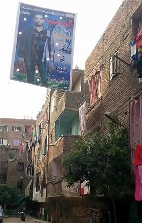 A banner bearing a picture of Mohamed Sayid, a militant killed in a March 19 gun battle with security forces, in which he is named as a "martyr", is seen on a street near his flat in the Matariya area of Cairo, in this picture taken April 13, 2014. REUTERS/Stringer