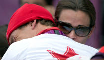 Canada's Simon Whitfield is hugged by his wife after crashing and retreating from the men's triathlon at Hyde Park during the Summer Olympics in London on Tuesday, August 7, 2012. THE CANADIAN PRESS/Sean Kilpatrick