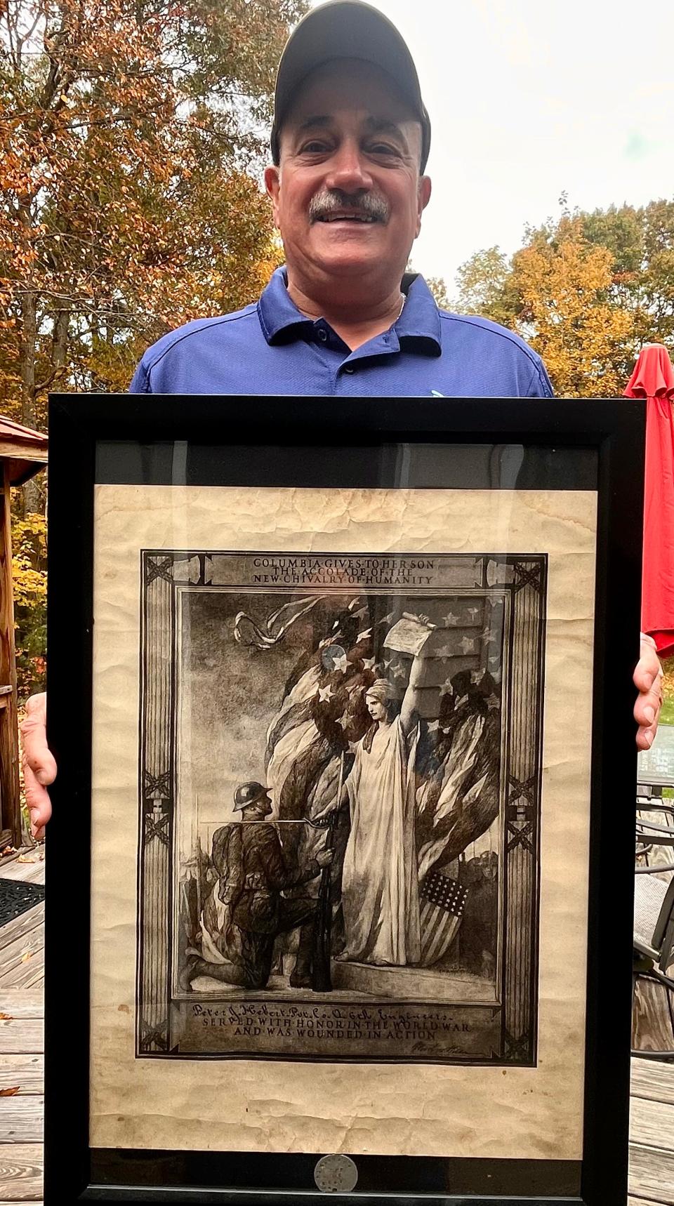 Dighton resident and Taunton native Vinnie Hebert holds a framed copy of his grandfather Peter Hebert's World War I Presidential Wound and Killed in Action Certificate.