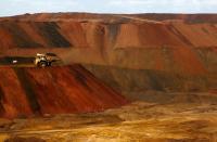 FILE PHOTO: A truck carrying iron ore moves along a road at the Fortescue Metals Group Christmas Creek iron ore mine in the Pilbara region of Western Australia