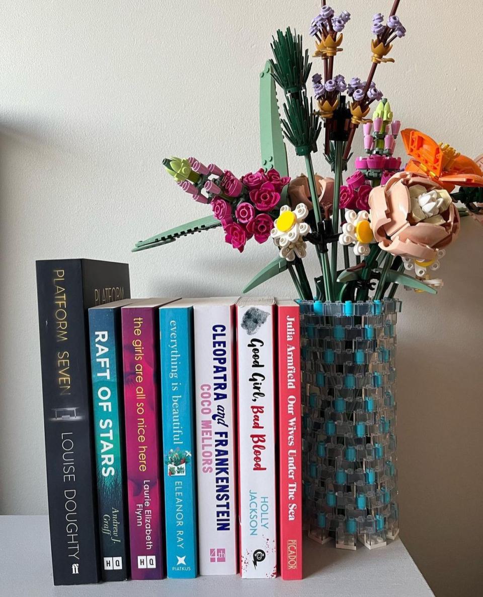 a vase of flowers sits on a shelf