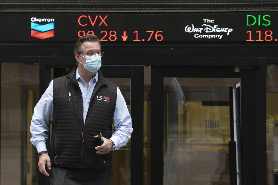 IMAGE DISTRIBUTED FOR THE NEW YORK STOCK EXCHANGE - Trader Steven Capo wears a protective face mask outside the New York Stock Exchange as the trading floor partially reopens on Tuesday, May 26, 2020, in New York. The floor, known worldwide for an anarchic atmosphere with traders shouting orders over one another, has been closed since mid-March due to the coronavirus outbreak. The NYSE says fewer traders will be on the floor at a given time for now in order to support six-feet social distancing requirements. They also must wear masks. (Mark Lennihan/AP Images for the New York Stock Exchange)