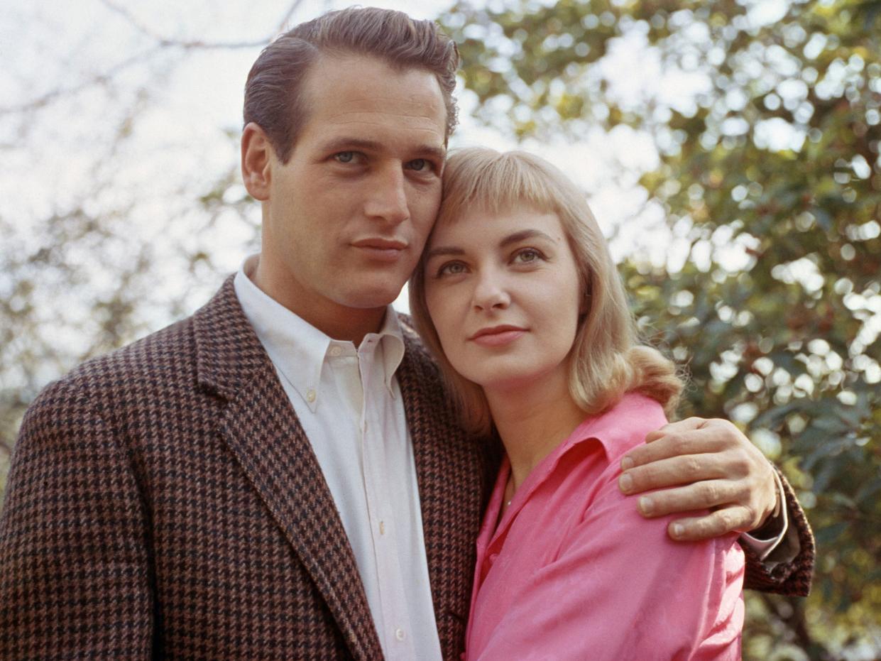 Paul Newman with his arm around Joanne Woodward