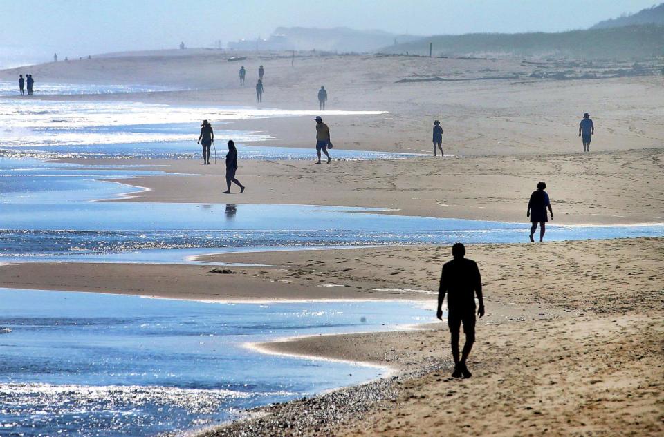 PHOTO: People stroll along Nauset Beach during the unseasonably warm weather, on Oct. 4, 2023. (Boston Globe via Getty Images, FILE)