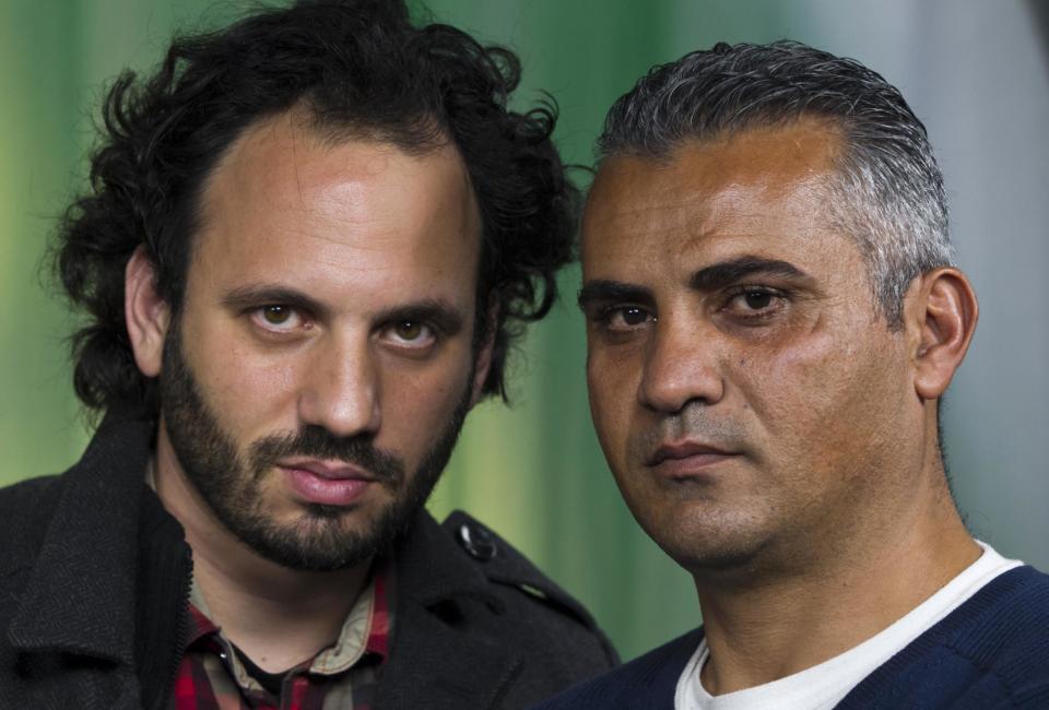 In this Tuesday, Feb. 5, 2013 photo, documentary film Co-directors, Israeli, Guy Davidi, left, and Palestinian, Emad Burnat, pose for a photo after an interview in Los Angeles. Their 2011 documentary film, “5 Broken Cameras,” is nominated for an Oscar in the best Documentary Feature category. (AP Photo/Damian Dovarganes)