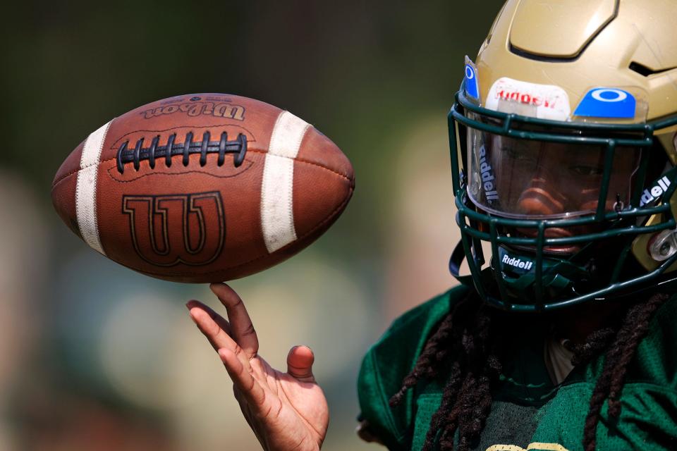 Fleming Island Golden Eagles running back Samuel Singleton #2 spins a ball during practice Tuesday, Aug. 16, 2022 at Fleming Island High School in Jacksonville. 