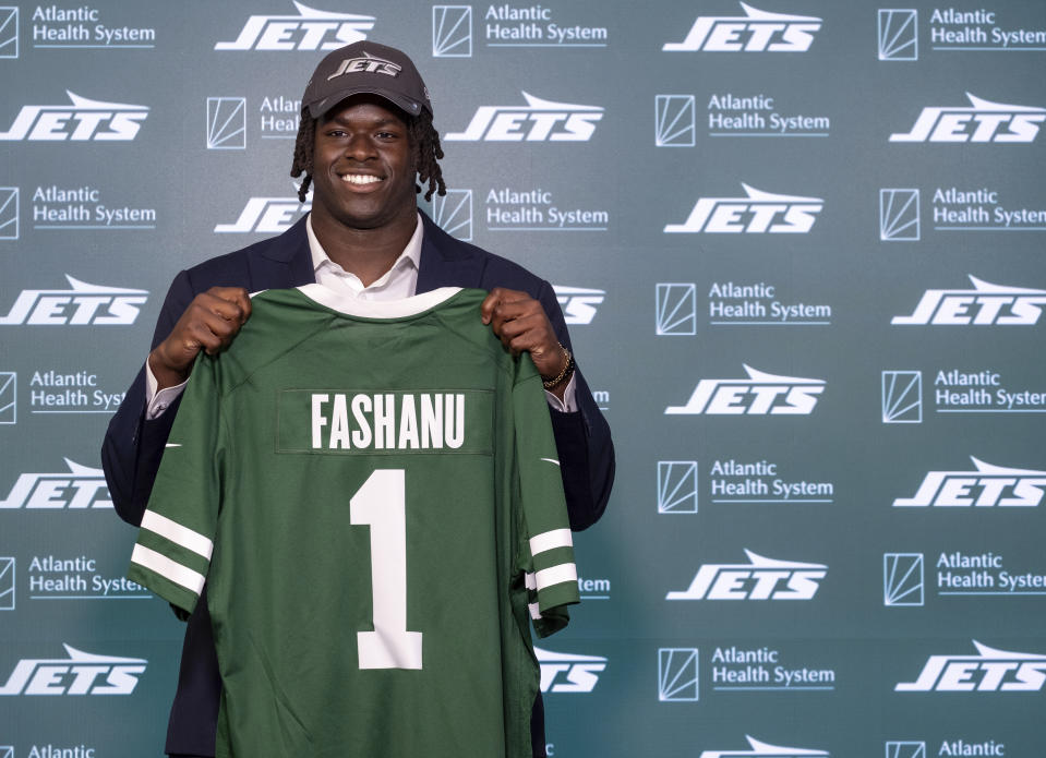 New York Jets offensive tackle Olu Fashanu holds his jersey at the team's training facility in Florham Park, N.J., Friday, April 26, 2024. Fashanu, a Penn State offensive tackle, was selected at No. 11 overall by New York after the Jets traded down one spot Thursday night. (AP Photo/Craig Ruttle)