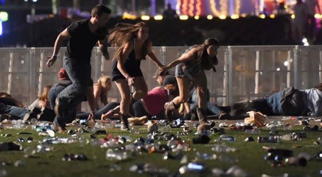 Festival goers flee the scene after Stephen Paddock opened fire from a hotel window. Source: Getty