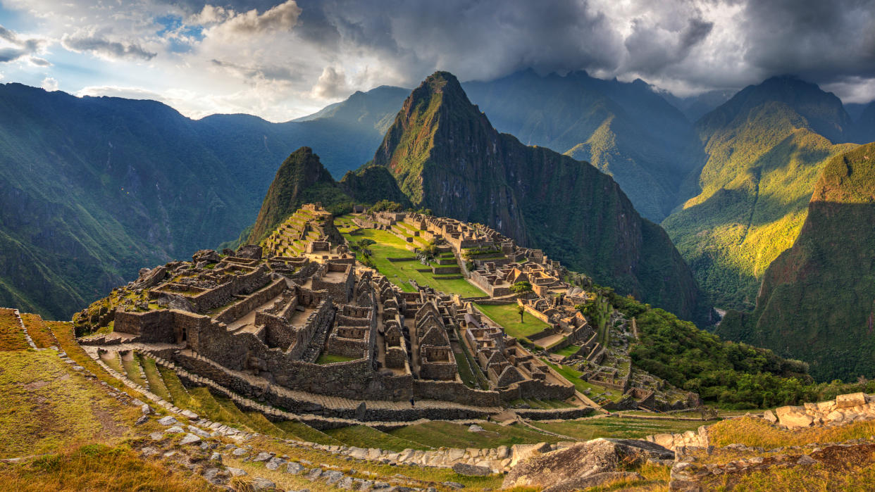  A view of Machu Picchu's rocky ruins from a mountaintop.  