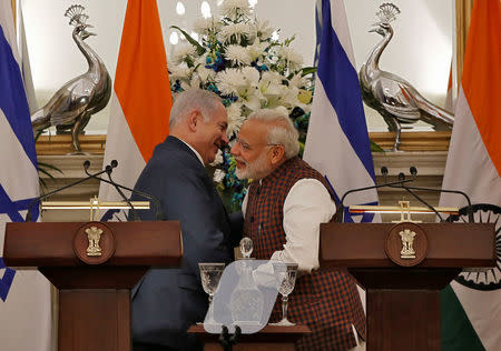 Israeli Prime Minister Benjamin Netanyahu and his Indian counterpart Narendra Modi hug after attending a signing of agreements ceremony at Hyderabad House in New Delhi, India January 15, 2018. REUTERS/Adnan Abidi/Files