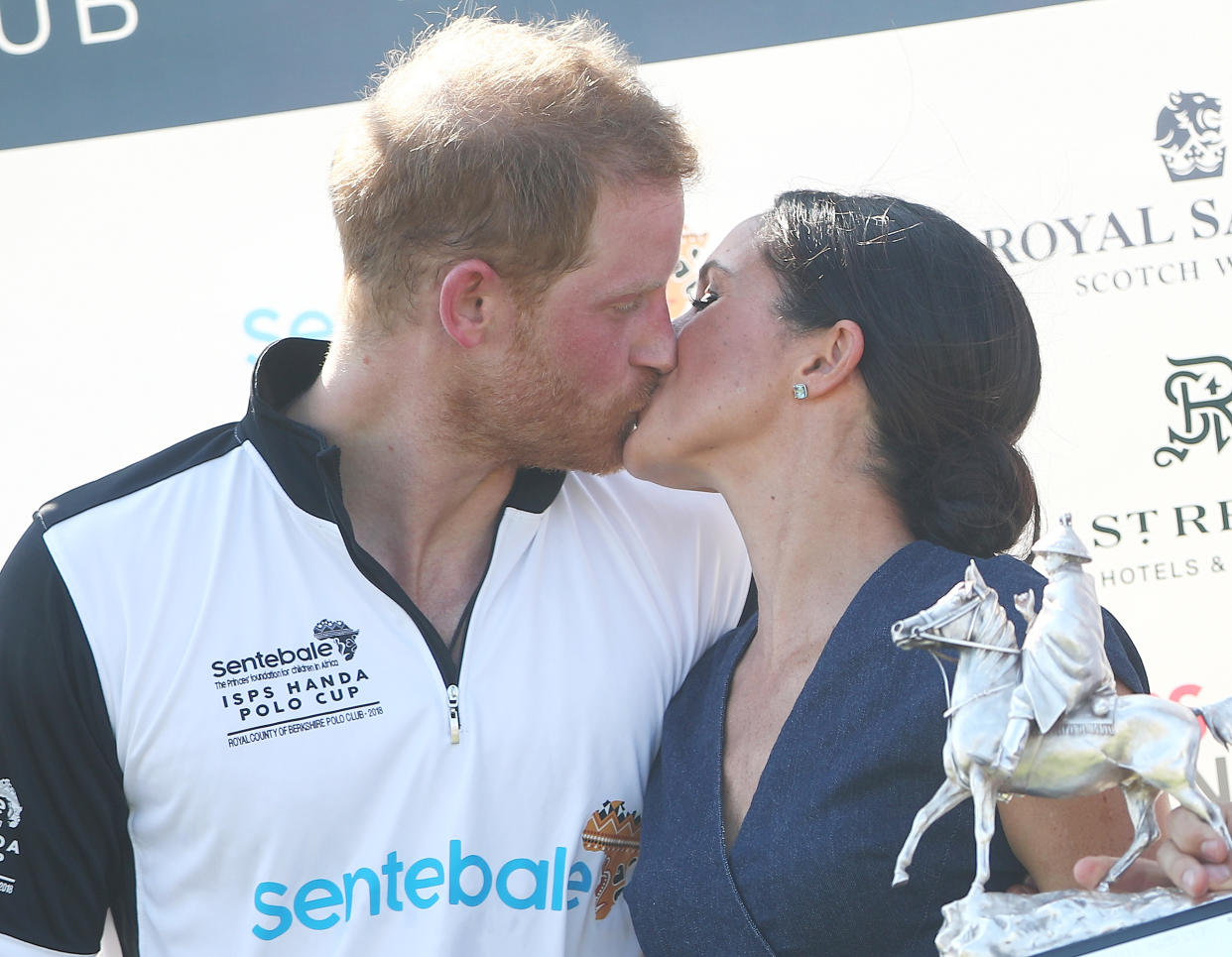 Britain's Prince Harry kisses his wife Meghan the Duchess of Sussex after a charity polo match in Windsor, Britain, July 26, 2018. REUTERS/Hannah McKay