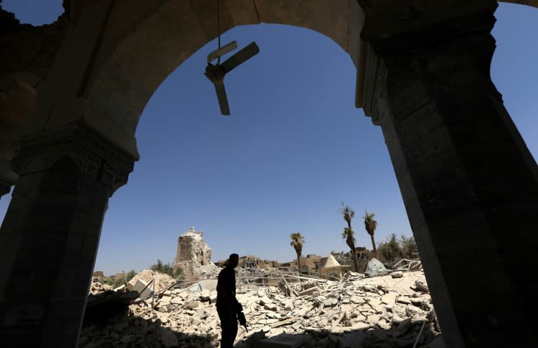 A member of the Iraqi forces walks in the rubble near the destroyed ancient leaning minaret known as the "Hadba" (Hunchback) in Mosul's Old City on July 30, 2017