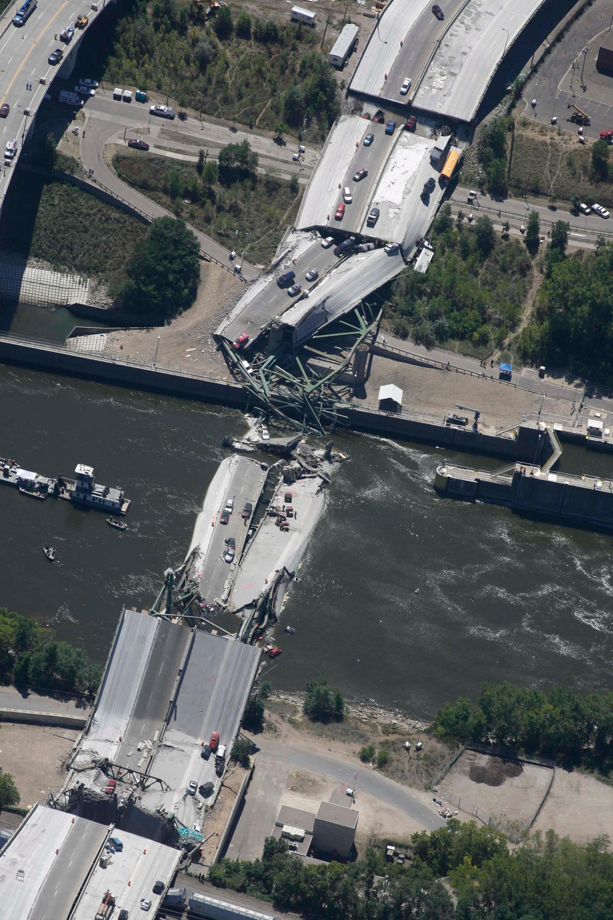 MINNEAPOLIS, Minn. - 8/2/2007 - Vehicles rest in this aerial photograph of a collapsed section of the I-35W bridge north of Minneapolis. The eight-lane bridge was undergoing repair work when it broke apart during rush hour 8/1 sending at least 50 vehicles into the Mississippi River.