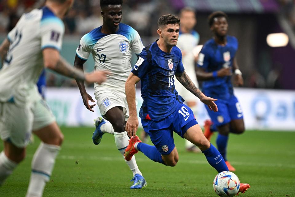 USA&#39;s forward #10 Christian Pulisic (C) runs with the ball during the Qatar 2022 World Cup Group B football match between England and USA at the Al-Bayt Stadium in Al Khor, north of Doha on November 25, 2022. (Photo by Paul ELLIS / AFP) (Photo by PAUL ELLIS/AFP via Getty Images)