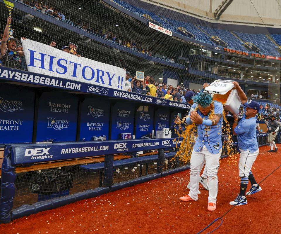 Tampa Bay Rays designated hitter Harold Ramirez, front right, is doused by teammates Jose Siri and Manny Navarro after defeating the Boston Red Sox in a baseball game in St. Petersburg, Fla., Thursday, April 13, 2023. (Ivy Ceballo/Tampa Bay Times via AP)