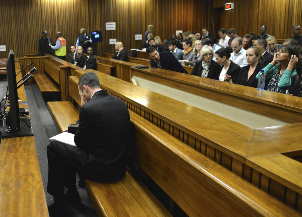 Oscar Pistorius sits in the dock on the second day of his trial at the high court in Pretoria, South Africa, Tuesday, March 4, 2014. Pistorius is charged with murder for the shooting death of his girlfriend, Reeva Steenkamp, on Valentines Day in 2013. (AP Photo/Antoine de Ras, Pool)