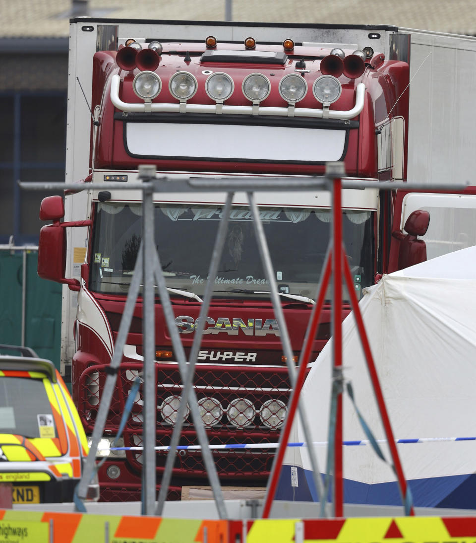 A truck that was found to contain a large number of dead bodies, in Thurrock, South England, early Wednesday Oct. 23, 2019. Police in southeastern England said that 39 people were found dead Wednesday inside the truck container believed to have come from Bulgaria. (Stefan Rousseau/PA via AP)