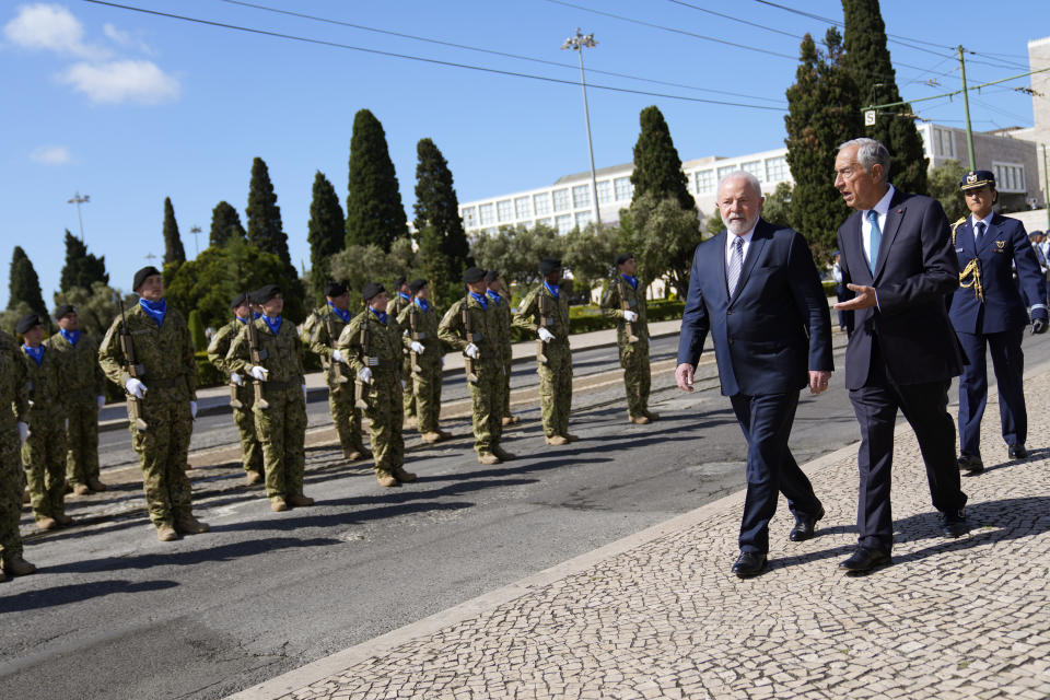 Brazilian President Luis Inacio Lula da Silva and Portuguese President Marcelo Rebelo de Sousa reviewing the troops during a welcome ceremony outside the 16th century Jeronimos monastery in Lisbon, Saturday, April 22, 2023. Lula da Silva is in Lisbon for a four day state visit to Portugal. (AP Photo/Armando Franca)