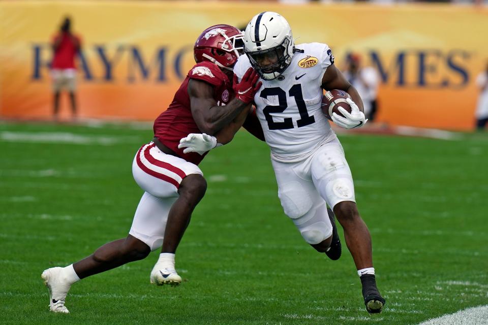 Penn State running back Noah Cain (21) gets shoved out of bounds by Arkansas defensive back Joe Foucha during the Outback Bowl. Cain, an expected transfer, could finish his college career somewhere in the South. He grew up in Louisiana and Texas and played in Florida. (AP Photo/Chris O'Meara)