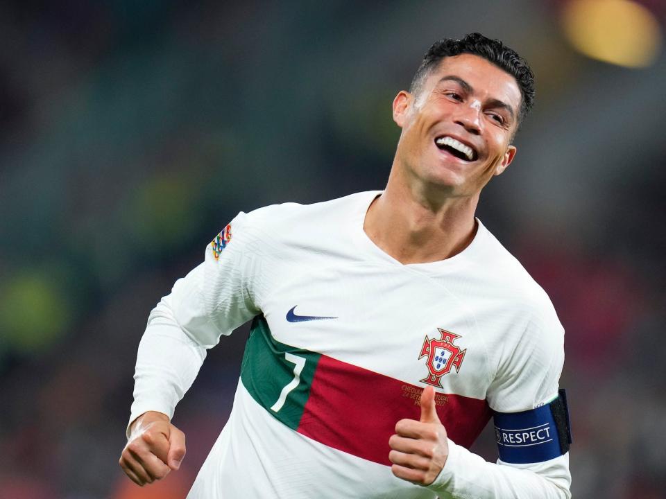 Cristiano Ronaldo smiles while running during a Portugal soccer match.