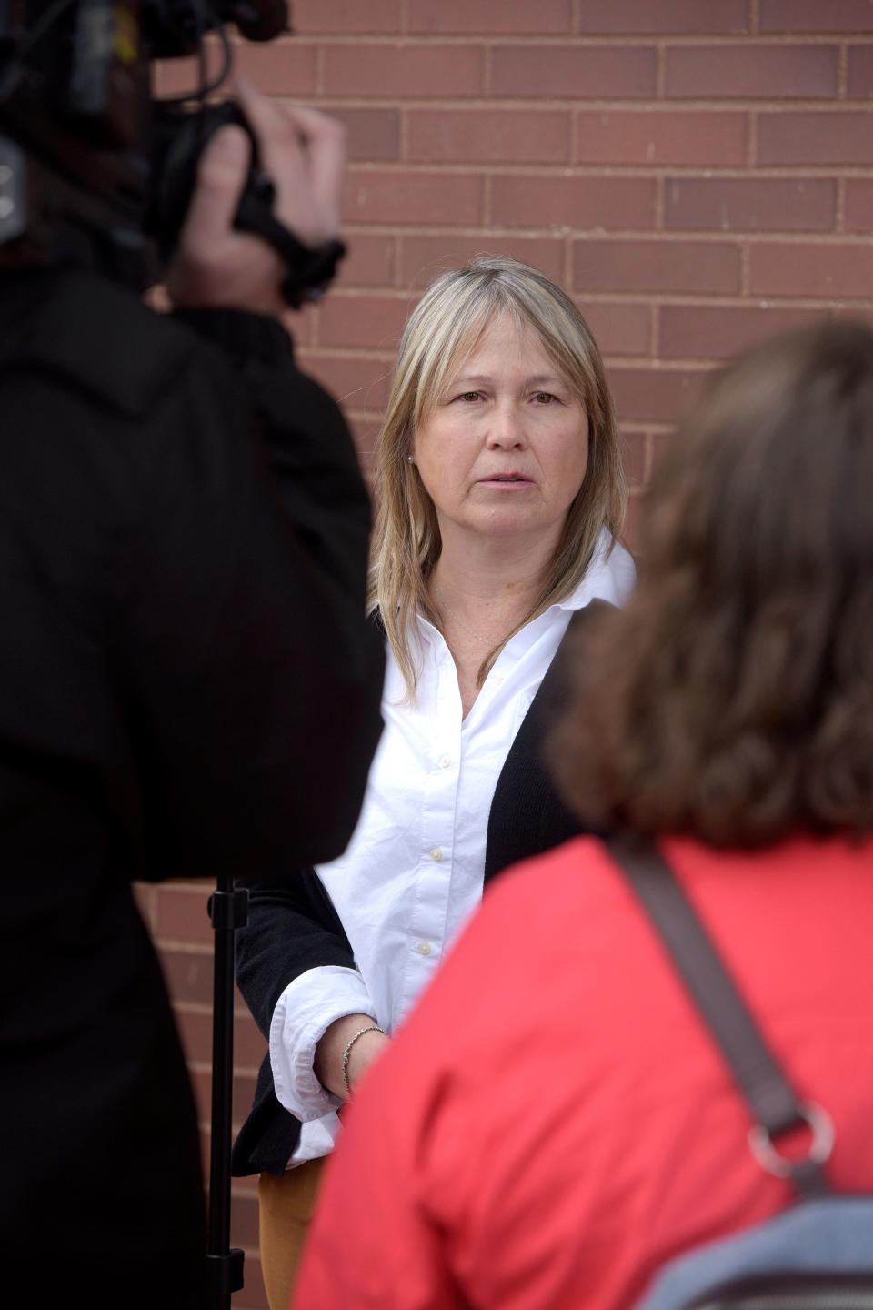 Erin Caviola, of Ridgefield, talks with the media outside Danbury Superior Court on Wednesday, March 1, 2023, in Danbury, Conn. Michael Konschak is facing charges after he allegedly killed, beheaded and skinned Caviola's family dogs. Konschak, a hunter who told authorities he killed and skinned what he thought were two coyotes, but later discovered they were a Connecticut family's pet German shepherds, has been criminally charged.