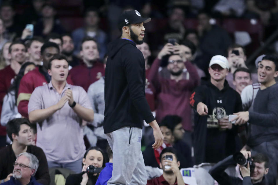 Boston College fans applaud as Boston Celtics forward Jayson Tatum, who played for Duke, arrives during the first half of an NCAA college basketball game in Boston, Tuesday, Feb. 4, 2020. (AP Photo/Charles Krupa)