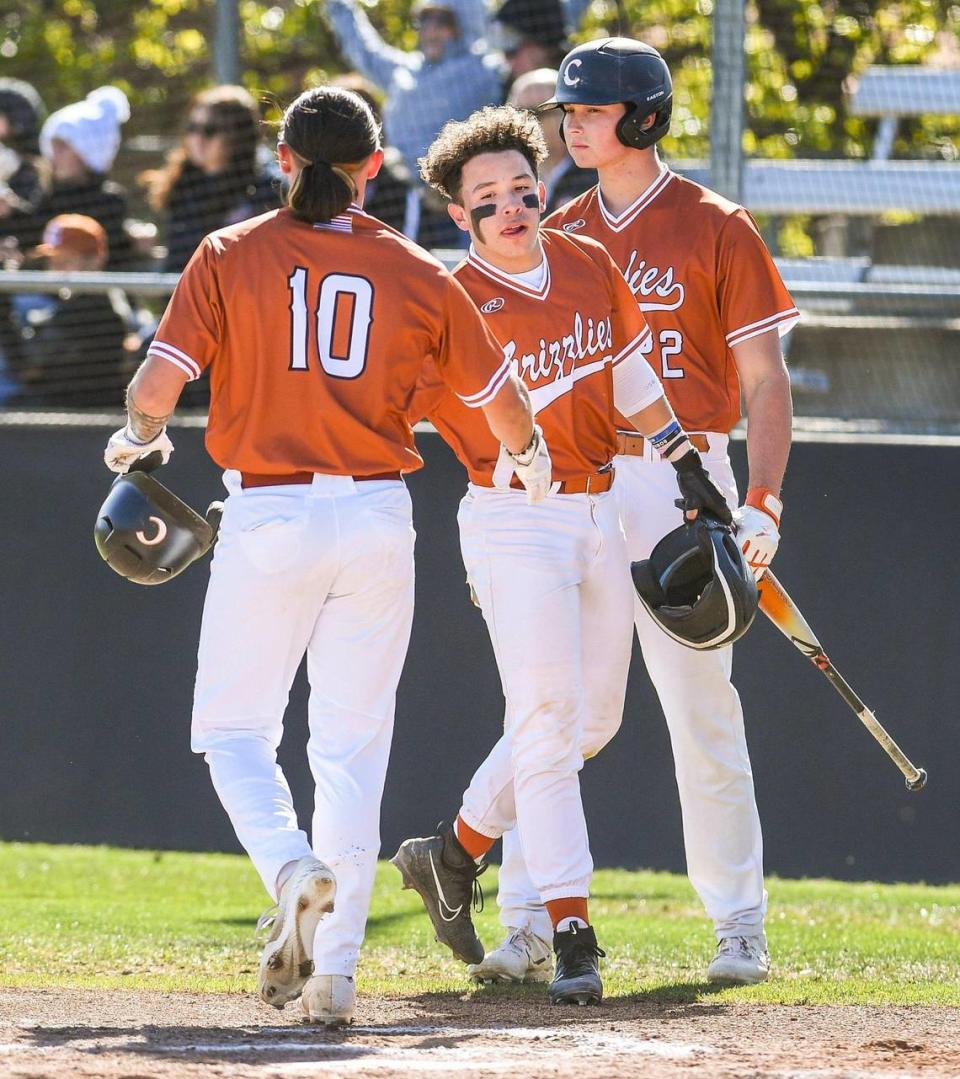 Central’s Dayton Tafoya, left, and Josh Barajas, celebrate scoring on Dallan Alles’ double as Nico Gaucin gets ready to hit in the first inning of their game against Garza at Central High East on Monday, April 4, 2023.