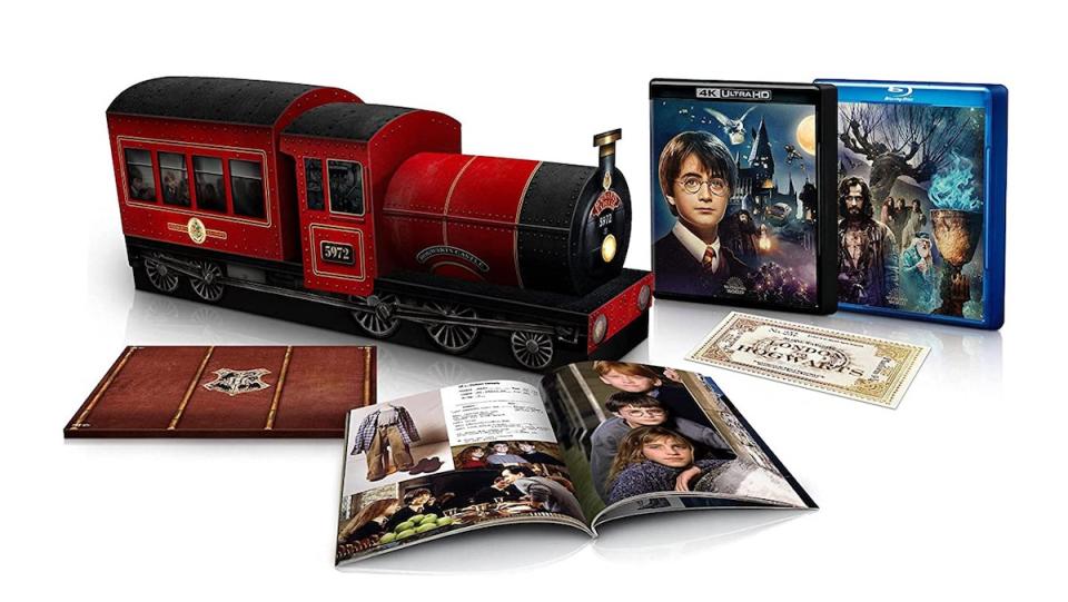 A Hogwarts Express box surrounded by harry Potter Blu-rays, books, and collectibles