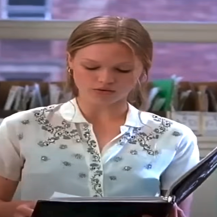 Julia in the movie reading from a loose-leaf notebook in a classroom