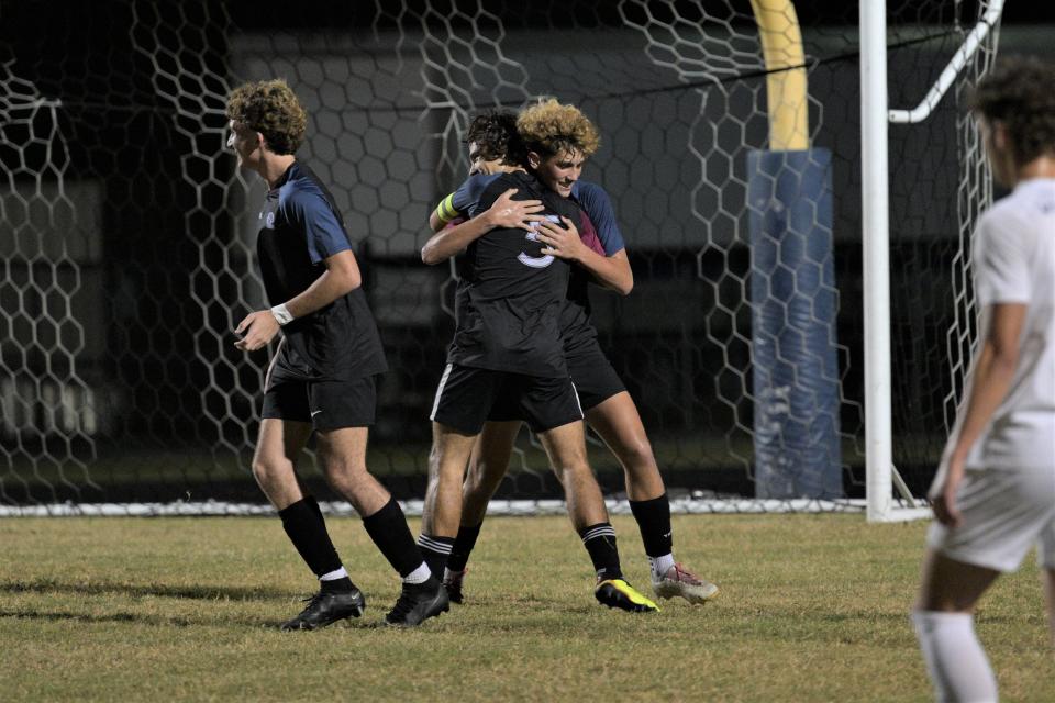 Dwyer's Roy Quest hugs his teammates after the Panthers score a goal in their comeback bid against West Boca in the district championship game (Jan. 31, 2023).