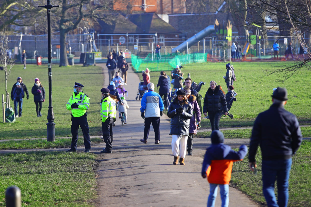 People walk on Clapham Common in London during England's third national lockdown to curb the spread of coronavirus. Under increased measures people can no longer leave their home without a reasonable excuse and schools must shut for most pupils.