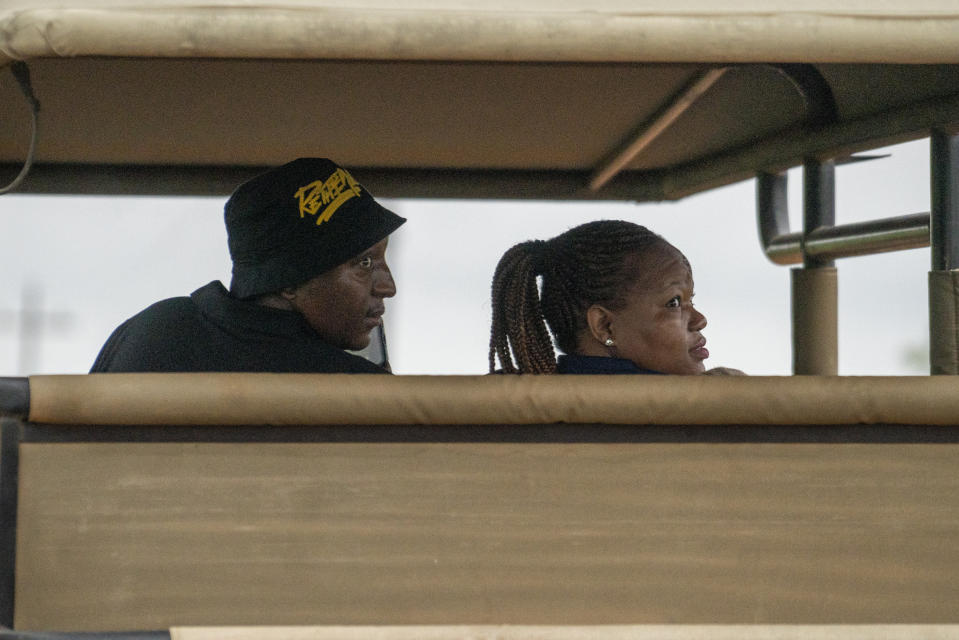 Tebogo Masiu, and Smagele Twala look for wildlife during a game drive in the Dinokeng game reserve near Hammanskraal, South Africa Sunday Dec. 5, 2021. Recent travel bans imposed on South Africa and neighboring countries as a result of the discovery of the omicron variant in southern Africa have hammered the country’s safari business, already hard hit by the pandemic. (AP Photo/Jerome Delay)