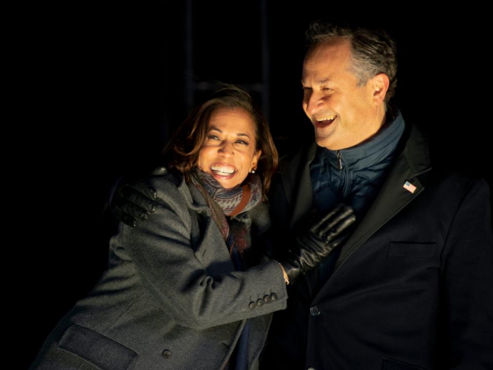 Kamala Harris and Doug Emhoff smile and hold each other