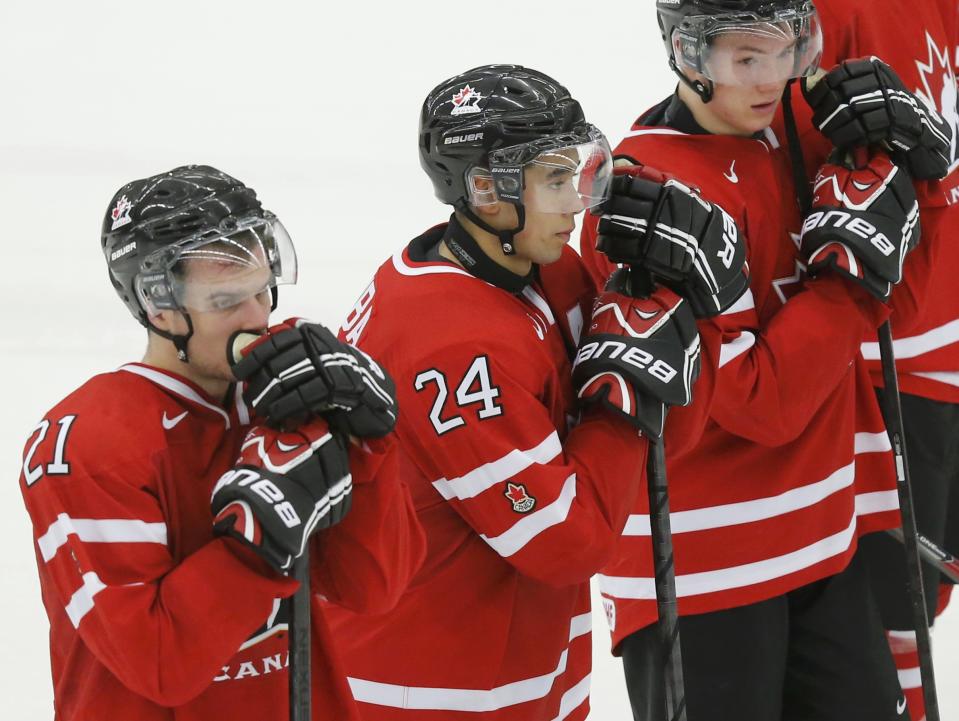 Canada's Scott Laughton (L) Matt Dumba and Curtis Lazar (R) react after their loss to the Czech Republic in their IIHF World Junior Championship ice hockey game in Malmo, Sweden, December 28, 2013. REUTERS/Alexander Demianchuk (SWEDEN - Tags: SPORT ICE HOCKEY)