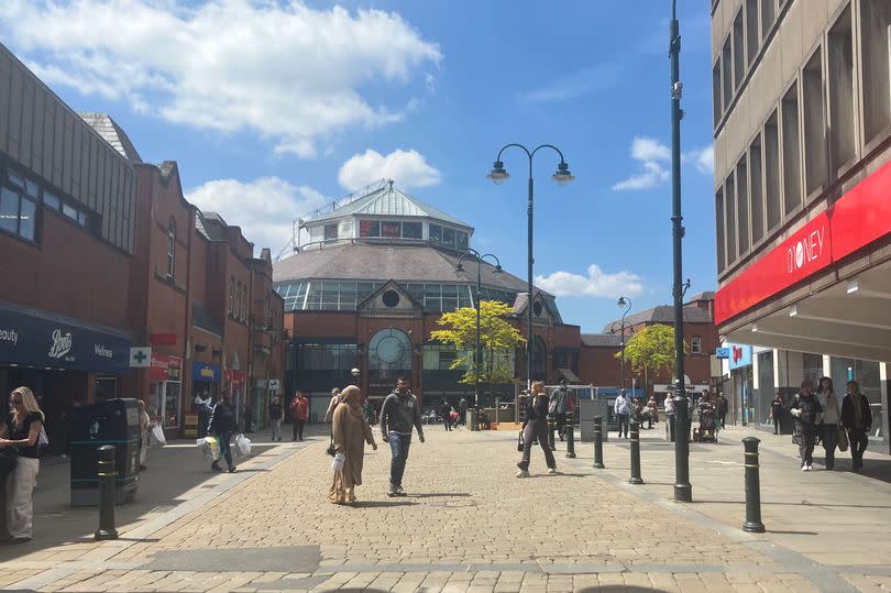 Oldham town centre in front of Spindles on a sunny day.