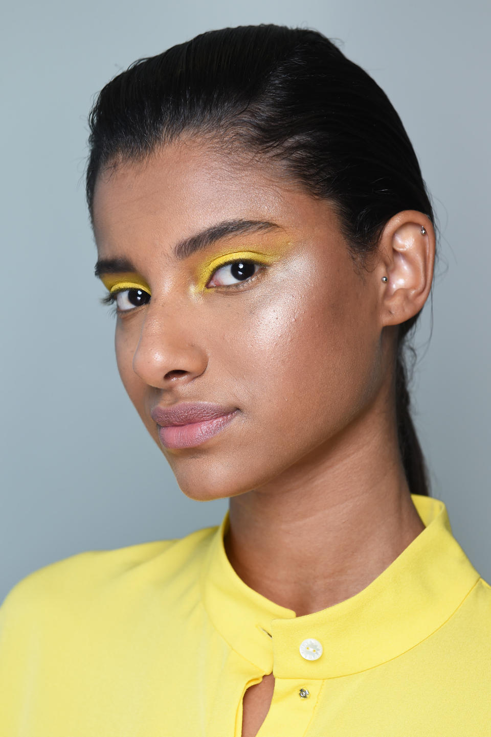 <p>A model wears matchy-matchy bright yellow eyeshadow. (Photo: NARS) </p>